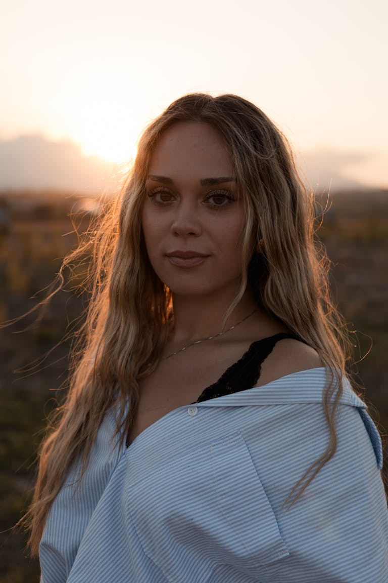 Portrait of a woman in golden hour light, showcasing serene beauty.